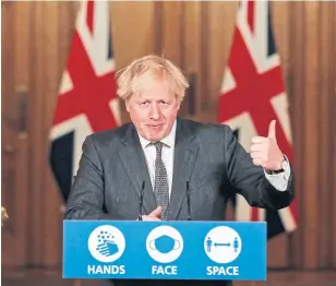  ?? HEATHCLIFF O’MALLEY THE ASSOCIATED PRESS ?? British Prime Minister Boris Johnson says now is the time to keep focus. “The hope of the vaccine and testing alone are not going to be enough for the next few weeks, and possibly longer.”