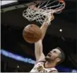  ?? TONY DEJAK — ASSOCIATED PRESS ?? Kevin Love dunks against the Heat during the first half Nov. 28.