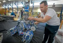  ??  ?? Lego fanatic Brian Cook puts the final touches on the space station in his elaborate sci-fi diorama at Barber Hall for the Palmerston North Brick Show.