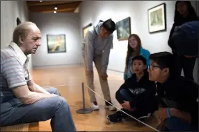  ?? NWA Democrat-Gazette File Photo/CHARLIE KAIJO ?? Students from Holy Family Cathedral School of Tulsa, Okla., look at a piece called “Man on a Bench” at Crystal Bridges in Bentonvill­e. Outside observers and local artists say Crystal Bridges has become an example for other museums and a way for people of any background to access the arts since it opened in late 2011.
