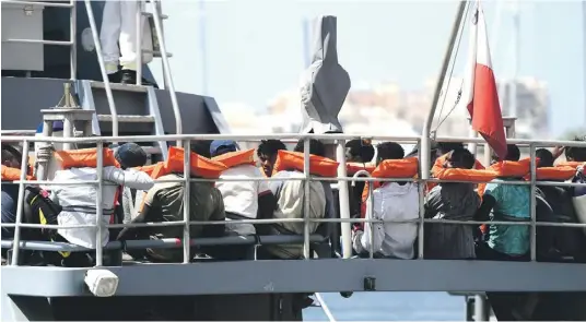  ?? ?? Migrants being brought to Malta on an AFM vessel. PHOTO: JONATHAN BORG