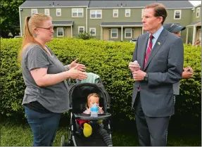  ?? DANA JENSEN THE DAY ?? Sen. Richard Blumenthal talks with Branford Manor Apartments resident Valarie Levy, left, with her daughter, Azrielle, 2, about her concerns May 20 during his visit to the apartment complex in Groton.