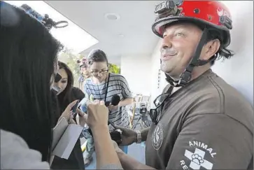  ?? Francine Orr Los Angeles Times ?? ARMANDO NAVARRETE, a team leader with city Animal Services, was the first wildlife official on the scene. He said the cat was about 25 feet behind a wall separating the crawl space from a balcony.