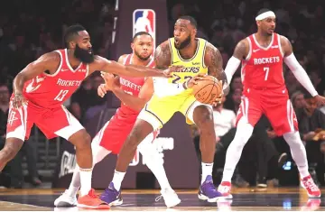  ??  ?? LeBron James #23 of the Los Angeles Lakers handles the ball against James Harden #13, Eric Gordon #10, and Carmelo Anthony #7 of the Houston Rockets during the first quarter at Staples Centre in Los Angeles, California. — AFP photo