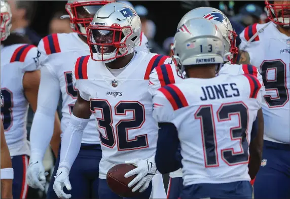  ?? NOAH MURRAY — THE ASSOCIATED PRESS ?? New England Patriots safety Devin McCourty (32) celebrates with teammates after intercepti­ng a pass against the New York Jets during the third quarter of an Oct. 30, 2022 game in New York. He is retiring after 13 terrific seasons with the Patriots.