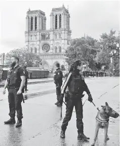  ??  ?? French police stand at the scene of a shooting incident near the Notre Dame Cathedral in Paris on June 6. — Reuters photo