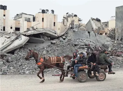  ?? HATEM ALI/AP ?? Palestinia­ns fleeing the Israeli ground offensive arrive in Rafah in the Gaza Strip Tuesday.