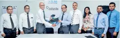  ??  ?? Delegates from SLIM and Sadaharith­a Plantation­s Ltd exchanging the MOU