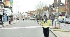  ?? REUTERS ?? A police officer near the site where the stabbing took place.