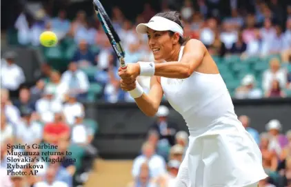  ??  ?? Spain’s Garbine Muguruza returns to Slovakia’s Magdalena Rybarikova Photo: AP