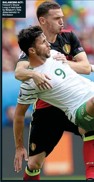  ??  ?? BALANCING ACT: Ireland’s Shane Long is held back by Belgium’s Toby Alderweire­ld in Bordeaux