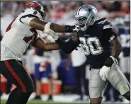  ?? (AP/Mark LoMoglio) ?? Dallas Cowboys defensive end DeMarcus Lawrence (right) defends Tampa Bay Buccaneers offensive tackle Tristan Wirfs during their Sept. 9 game. Lawrence is close to returning after being out since the opener with a broken foot as the medical outlook for the Cowboys is due to improve.