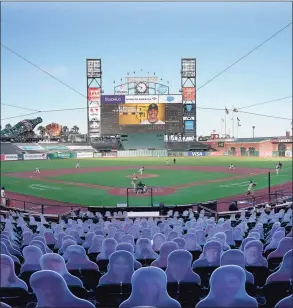  ?? Tony Avelar / Associated Press ?? Cardboard cutouts rest in seats at Oracle Park as the San Francisco Giants play the San Diego Padres in July.