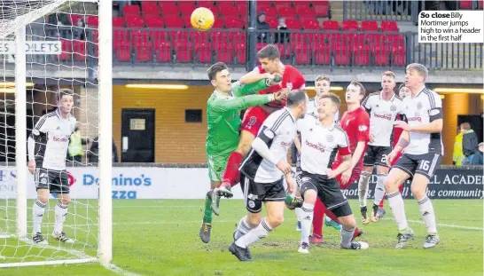  ??  ?? So closeBilly Mortimer jumps high to win a header in the first half