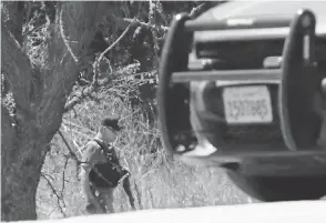  ??  ?? Deputies search the area where suspected gunman Santino William Legan may have entered as they investigat­e Sunday’s shooting. JOHN G. MABANGLO/EPA-EFE