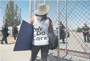  ?? JOE RAEDLE/GETTY IMAGES ?? Dedee Garcia Blase wears a vest that reads “We Do Care!” — a reference to a jacket worn by first lady Melania Trump last week — during a protest on Sunday in Tornillo, Texas.