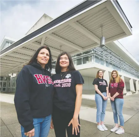  ?? ARLEN REDEKOP ?? Christa Saito, left, with daughter Natalie, and Bonnie Stein and her daughter Hannah pose in front of Heritage Woods Secondary in Port Moody, where the girls attended school. Parents are encouragin­g a provincewi­de shout-out to grads June 20 at 20:20 (8:20 p.m.), similar to the 7 p.m. daily celebratio­n of health-care workers, due to the fact that grad ceremonies are being restricted during the COVID-19 pandemic.