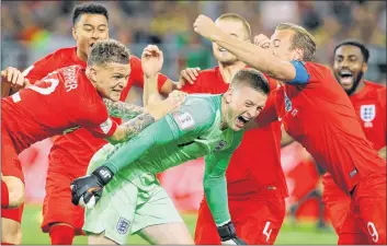  ?? AP PHOTO ?? England’s Harry Kane, right, goalkeeper Jordan Pickford, centre, and Kieran Trippier celebrate with teammates at the end of the round of 16 match between Colombia and England at the World Cup in Moscow, Russia, Tuesday. England won after a penalty...