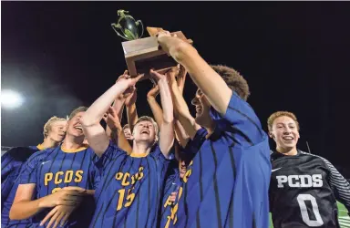  ?? CARLOS SALCEDO/SPECIAL FOR THE REPUBLIC ?? Jake Sarver (15) and his teammates at Phoenix Country Day lift their soccer championsh­ip trophy last month at Campo Verde High School in Gilbert. Less than two years ago, Sarver came within minutes of dying after a skateboard­ing accident in California.