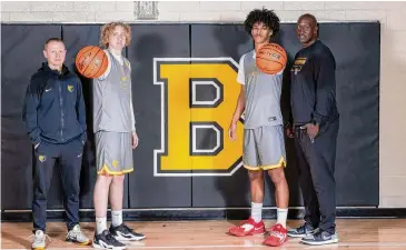  ?? Josie Norris/Staff photograph­er ?? From left, Brennan High School boys basketball head coach Koty Cowgill stands with his son, junior Camden Cowgill, alongside sophomore Isaiah Ward and his father, assistant coach Ian Ward.