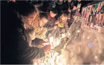  ?? AFP ?? Mourners light candles for the victims of Ukraine Internatio­nal Airlines flight 752 which crashed in Iran during a vigil at Mel Lastman Square in Toronto, Ontario, in January.