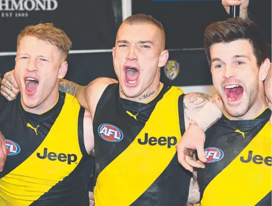  ?? Picture: GETTY IMAGES ?? Dylan Grimes, Dustin Martin and Trent Cotchin don’t hide their excitement as they sing the Richmond song after defeating Geelong.