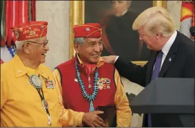 ?? OLIVER CONTRERAS/SIPA USA ?? President Donald Trump greets members of the Native American code talkers on Monday during an event in the Oval Office of the White House in Washington, D.C.