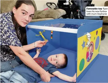  ??  ?? Favourite toy Ryan loves his new funbox with mum Stephanie