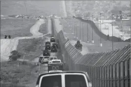  ?? ASSOCIATED PRESS ?? IN THIS MARCH 13 FILE PHOTO, A MOTORCADE carrying President Donald Trump drives along the border in San Diego. California has rejected the federal government’s initial plans for National Guard troops to the border because the work is considered too...