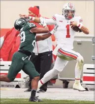  ?? Gregory Shamus / Getty Images ?? Ohio State’s Justin Fields tries to get past the tackle of Michigan State’s Shakur Brown on Dec. 5.