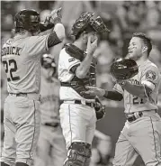  ?? John Sleezer / Kansas City Star ?? To the dismay of Royals catcher Drew Butera, center, Josh Reddick, left, greets Jose Altuve after Altuve’s homer put the Astros up 3-1 in the ninth Thursday.