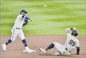  ?? Adrian Kraus / Associated Press ?? toronto second baseman Jonathan Villar, left, forces out new York’s Aaron Judge, right, at second and throws to complete a double play.