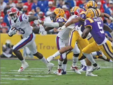  ?? Tom Morris/Louisiana Tech Sports Informatio­n ?? On the run: Louisiana Tech running back Jaqwis Dancy, a former standout at Junction City, runs the ball during the Bulldogs' game at LSU last month. After spending much of September on the road, Louisiana Tech returns home to host UAB in Conference USA play today.