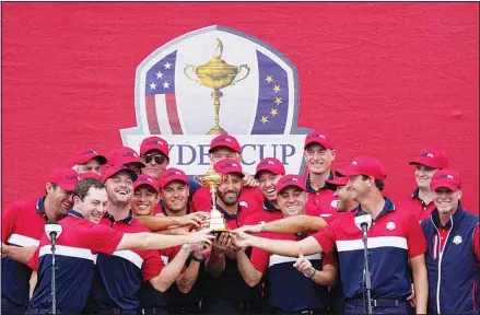  ?? ?? Team USA players pose with the trophy after the Ryder Cup matches at the Whistling Straits Golf Course, on Sept. 26, in Sheboygan, Wisconsin. (AP)