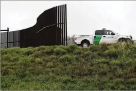  ?? ERIC GAY / ASSOCIATED PRESS 2016 ?? A U.S. Customs and Border Patrol agent passes along a section of border wall in Hidalgo, Texas. The GOP-controlled House passed a spending bill to give the Pentagon a massive spending boost and deliver a $1.6 billion down payment for President Donald...