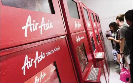  ?? BLOOMBERG PIC ?? AirAsia Bhd ticket kiosks at Kuala Lumpur Internatio­nal Airport 2 in Sepang, Selangor. The company expects robust demand for its tickets online.