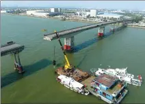  ?? ZHENG ERQI / CHINA DAILY ?? Rescue work is carried out on Thursday after a barge hit the pier of the Lixinsha Bridge in Guangzhou, Guangdong province, causing a portion of the bridge to break off.