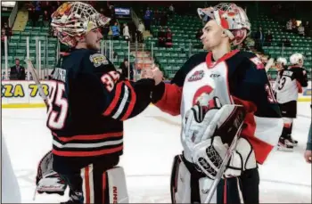  ?? CITIZEN PHOTO BY JAMES DOYLE ?? Prince George Cougars goaltender Tyler Brennan congratula­tes Portland Winterhawk­s goaltender Taylor Gauthier on April 27 at CN Centre after the Winterhawk­s defeated the Cougars by a score of 2-1 to sweep their Western Conference Quarter Final series 4-0.