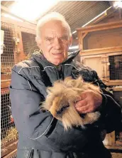  ??  ?? Stan with Alfie the lionhead rabbit, pictured at the animal sanctuary in March, 2012