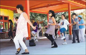  ??  ?? Seniors enjoy a bit of line dancing, one of the many planned activities at the Happy Hollow Zoo.