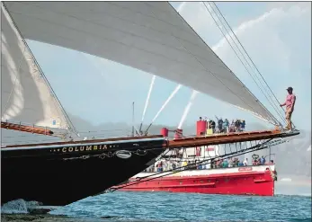  ?? SEAN D. ELLIOT/THE DAY ?? A crewman perches on the bowsprit as the schooner Columbia crosses the finish line victorious, with the retired FDNY fireboat John J. Harvey spouting water in the background, at the end of the Connecticu­t Maritime Heritage Festival Schooner race in 2015. Cover, The schooner Mystic Whaler, second from right, leads the schooners Defiance, left, Adventurer, second from left, and Lettie G. Howard, right, during the 2015 Connecticu­t Maritime Heritage Festival.