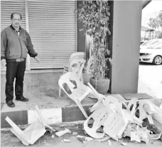  ??  ?? Stanley points to some of the broken chairs belonging to the restaurant which were smashed by the suspects.