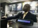  ??  ?? A plaincloth­ed police officer mans a position behind the counter at the Starbucks that has become the center of protests in Monday in Philadelph­ia.