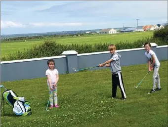  ??  ?? Young golfers practicing at Banna East, Ardfert last week, were from left, Laura and Amy Costello with Matthew Cahill. Photo Moss Joe Browne.