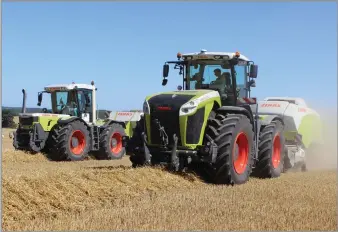  ?? ?? POWER GROWTH An original 315hp Xerion baling alongside today’s 530hp Xerion 5000 in the 25-year anniversar­y limited edition colour scheme