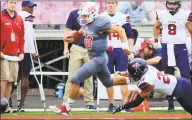  ?? Christian Abraham / Hearst Connecticu­t Media ?? Sacred Heart University quarterbac­k Kevin Duke carries the ball as Penn’s Tayte Doddy tries to catch him in a 2018 game. Sacred Heart’s scheduled games against Penn and Lafayette will not be played this season due to the Ivy and Patriot leagues’ adjustment­s in response to the coronaviru­s pandemic.