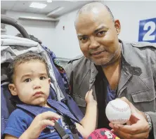  ?? STAFF PHOTOS BY NICOLAUS CZARNECKI ?? PRIORITIES: Hub expat Julio Bautista, above, left Miami Beach for Logan with his son and a David Ortizautog­raphed baseball. Martha Sykes, right, made her feelings known about Hurricane Irma as she returned to Boston from the Sunshine State.