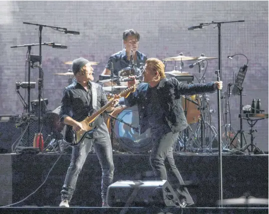  ?? Photo / Greg Bowker Visuals ?? U2 band members the Edge and Bono perform at Mt Smart Stadium last night as part of the Joshua Tree Tour.