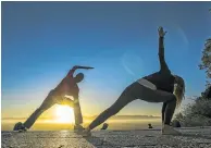  ?? Picture: DAVID HARRISON ?? EGALITARIA­N: Yoga practition­ers Josie van Rooyen and Karthik Parksh welcome the day at Rhodes Memorial