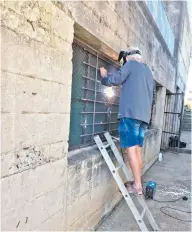  ?? ?? FOBNR members Vic Grobbler and Jason Stakemire were hard at work last week increasing the security of the storeroom at the reserve, thanks to a generous donation of burglar guards from Wayne’s Scrap Metal.